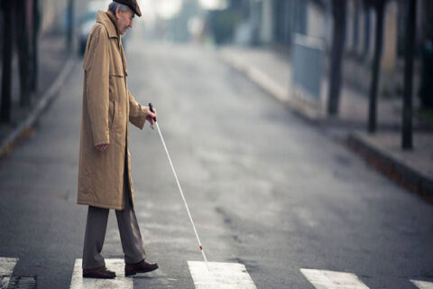 A Old man waling on the zebra crossing